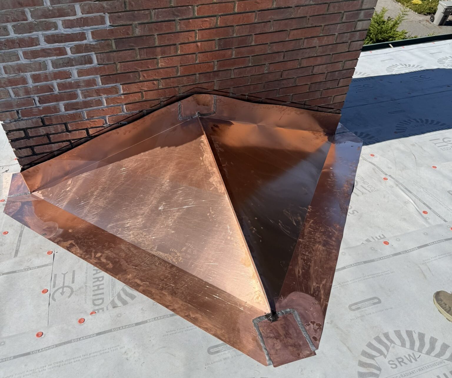 Custom sheet metal base of chimney on roof
